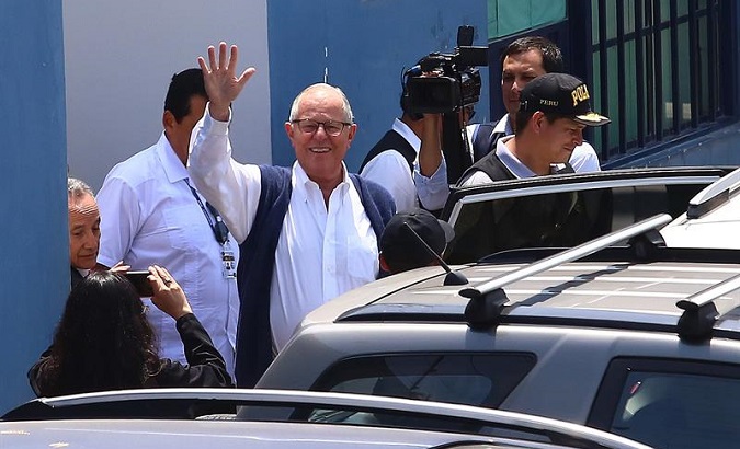 Former Peruvian President Pedro Pablo Kuczynski (center) salutes after leaving the headquarters of Legal Medicine after his arrest Wednesday in Lima, Peru.