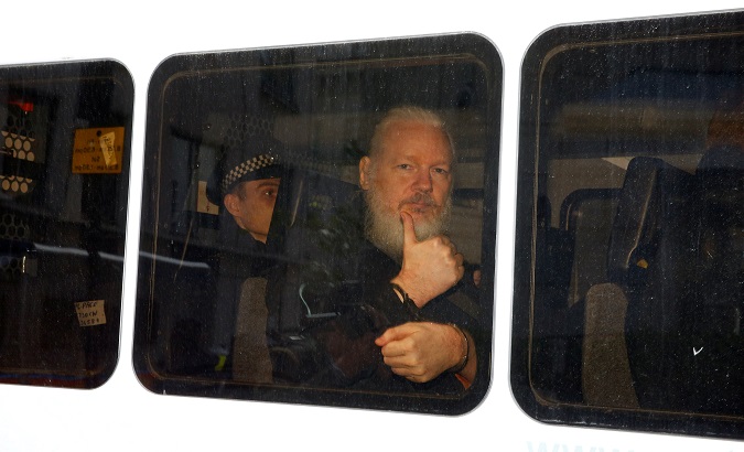 WikiLeaks founder Julian Assange is seen in a police van after was arrested by British police outside the Ecuadorian embassy in London, Britain April 11, 2019.