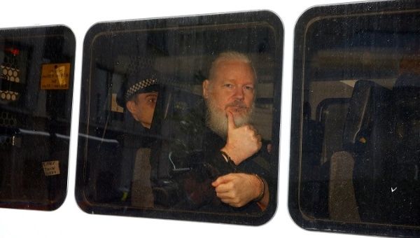 WikiLeaks founder Julian Assange is seen in a police van after was arrested by British police outside the Ecuadorian embassy in London, Britain April 11, 2019.