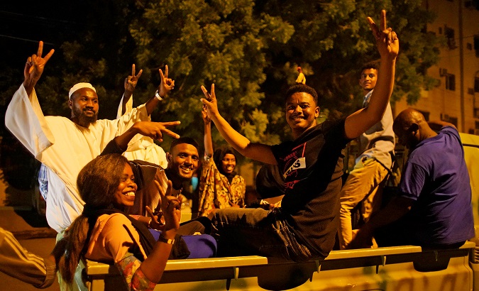 Sudanese demonstrators celebrate after the Defence Minister Awad Ibn Auf stepped down as head of the country's transitional ruling military council, as protesters demanded quicker political change, outside the Defence Ministry in Khartoum, Sudan, April 13, 2019.