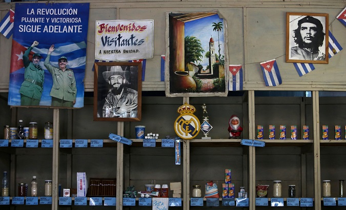 Poster showing late Cuban President Fidel Castro and his brother Raul hangs inside a subsidised state store, in Havana.