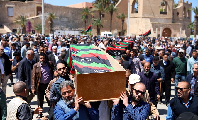 People carry a flag draped coffin of a victim of an overnight shelling, during a funeral at Martyrs' Square in Tripoli, Libya April 17, 2019.