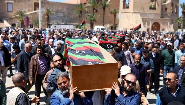 People carry a flag draped coffin of a victim of an overnight shelling, during a funeral at Martyrs' Square in Tripoli, Libya April 17, 2019. 
