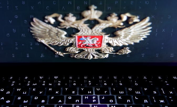 The Russian coat of arms is reflected in a laptop screen in this picture illustration.