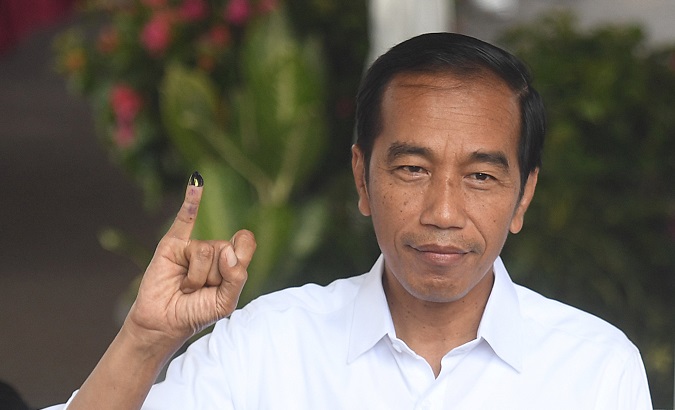 Indonesian President Joko Widodo displays an ink-stained finger after casting his ballots during elections in Jakarta.