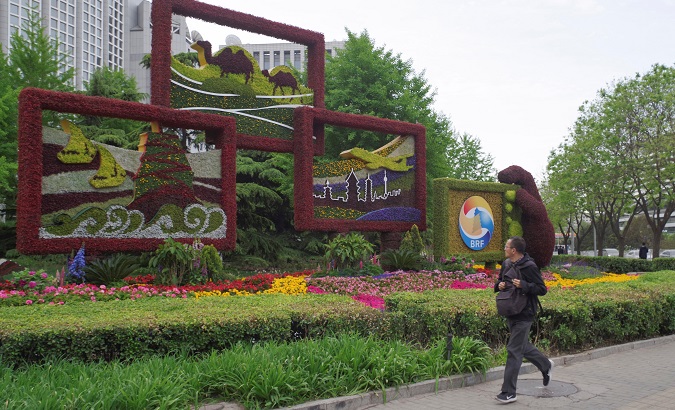 A man walks past a flower installation set up for the upcoming Belt and Road Forum in Beijing, China April 18, 2019.