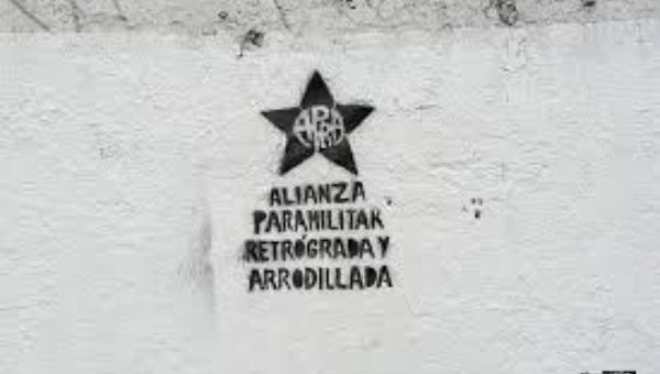 Graffiti showing alternate meanings for the APRA acroynm, which stands for American Popular Revolutionary Alliance, but is reinterpreted as Backwards and Servile Paramilitary Alliance.