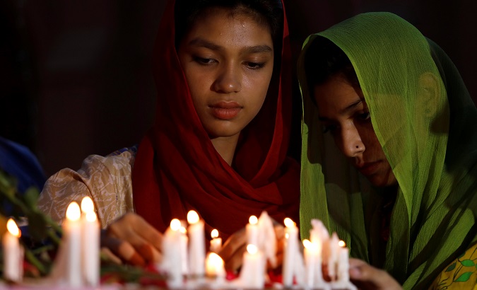 People light candles for the victims of Sri Lanka's serial bomb blasts, outside a church in Peshawar, Pakistan April 21, 2019.