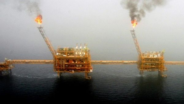 Gas flares from an oil production platform are seen at the Soroush oil fields.