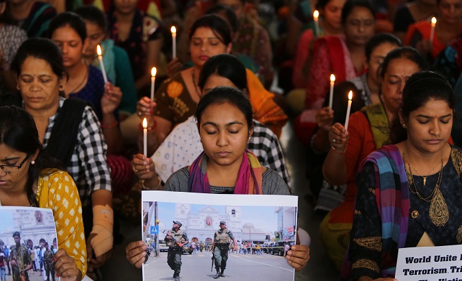 Teachers hold candles as they pray for the victims of Sri Lanka's serial bomb blasts, at a school in Ahmedabad, India, April 22, 2019.