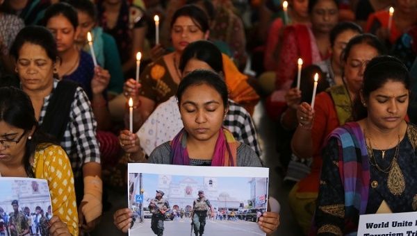 Teachers hold candles as they pray for the victims of Sri Lanka's serial bomb blasts, at a school in Ahmedabad, India, April 22, 2019. 