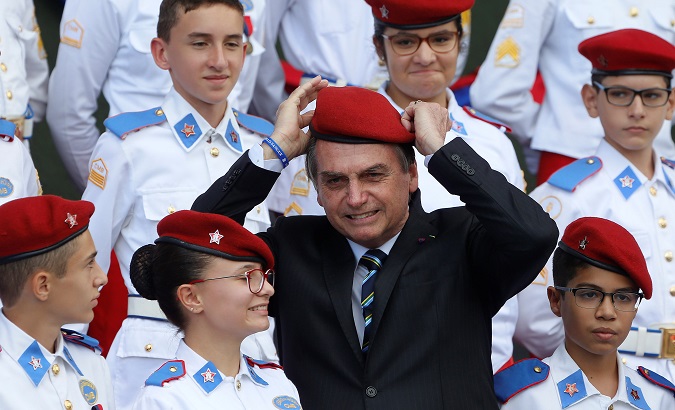 Brazil's President Jair Bolsonaro poses for a picture with students of the military college during an Army Day ceremony, in Brasilia, Brazil April 17, 2019.