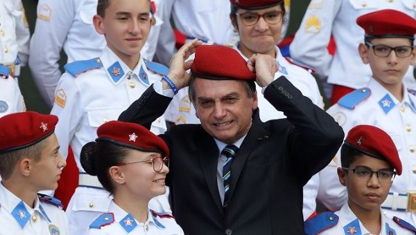 Brazil's President Jair Bolsonaro poses for a picture with students of the military college during an Army Day ceremony, in Brasilia, Brazil April 17, 2019. 