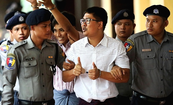 Detained Reuters journalists Wa Lone and Kyaw Soe Oo arrive at Insein court in Yangon, Myanmar, Aug. 27, 2018.