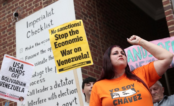 Demonstrators stand outside the entrance of the Embassy of Venezuela in Washington, U.S., April 25, 2019.
