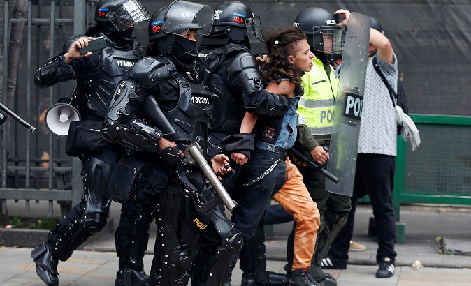 A man is arrested by the police during a protest for a national strike in Bogota.