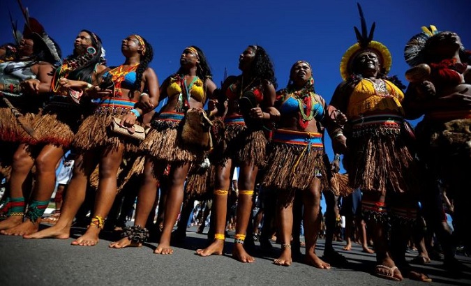 Wearing body paint and headdresses, Indigenous protesters brandished bows and arrows and beat drums while chanting resistance songs in Brazil on April 26,2019.