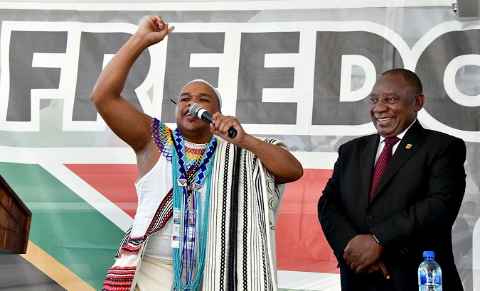 President Cyril Ramaphosa (R) watches a traditional healer at the Freedom Day national commemoration in Makhanda, South Africa, April 27 2019.