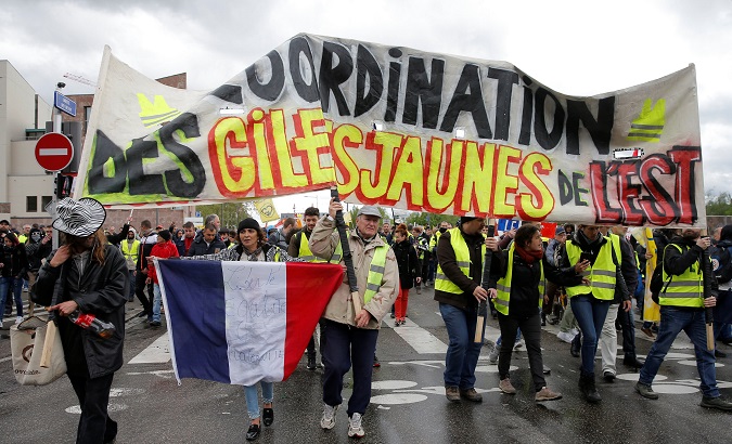 Protesters hold a banner saying 'Yellow Vests eastern side coordination' in Strasbourg, France, April 27, 2019.