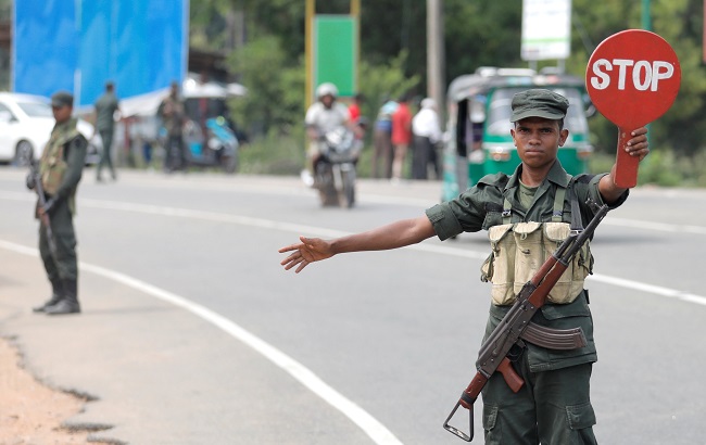 An army personnel member controls the traffic in the village of Kattankudy