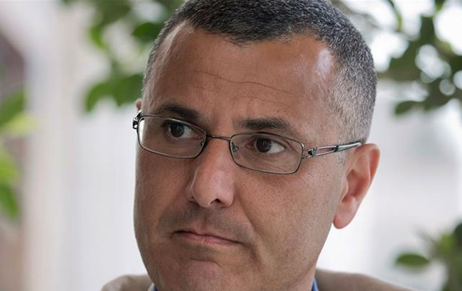 Omar Barghouti listens during an interview with the Associated Press in the West Bank city of Ramallah