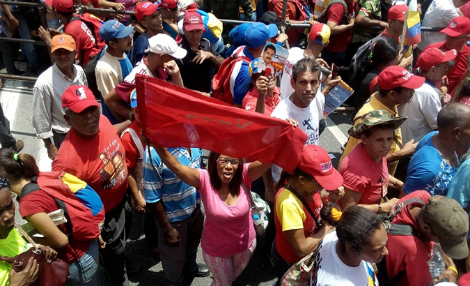 People hold flags and shout slogans in rallies in Caracas, Venezuela.
