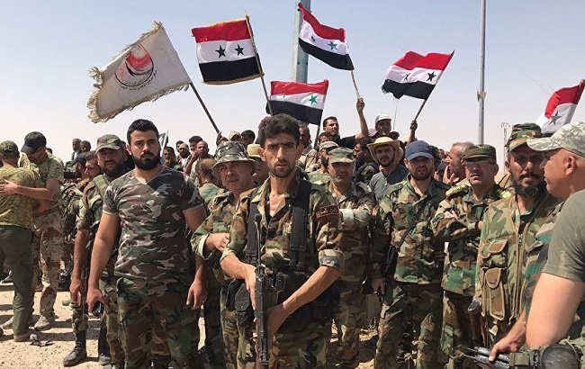 Syrian government forces pose for a photo before battle