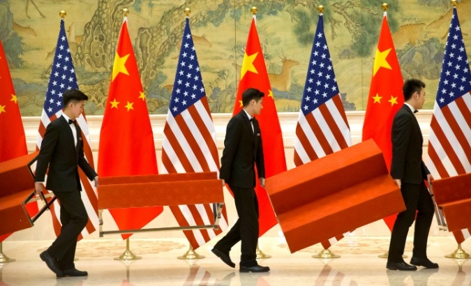 Aides set up platforms before a group photo with members of U.S. and Chinese trade negotiation delegations in Beijing, China, February 15, 2019.