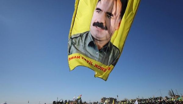 A banner with a picture of imprisoned Kurdish rebel leader Abdullah Ocalan is seen during a protest against the Turkish attacks on Afrin in Qamishli, Syria January 30, 2018. 