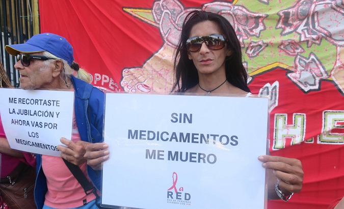 Argentines protest in front of the Health Ministry to request the regularization of medicine purchases in Buenos Aires, Argentina, Jan. 26, 2018. The right sign reads “I died without medicines”. The left sing reads “You cut off my retirement and now you go for the medicines.”