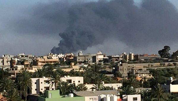 Smoke rises during a fight between members of the Libyan government forces and Eastern forces in Ain Zara, Tripoli.