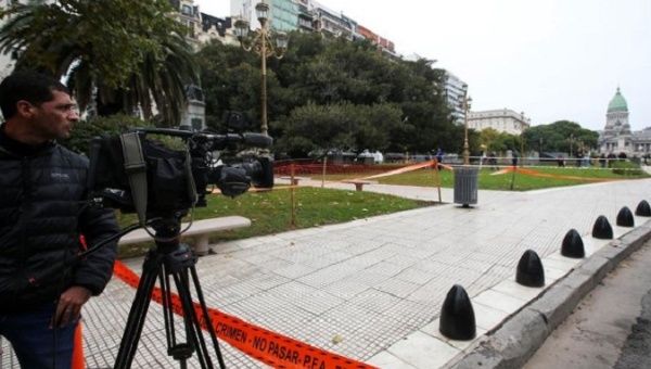 A cameraman works at the crime scene where Argentine Congressman Hector Olivares was injured and his adviser, Miguel Yadon, was killed.