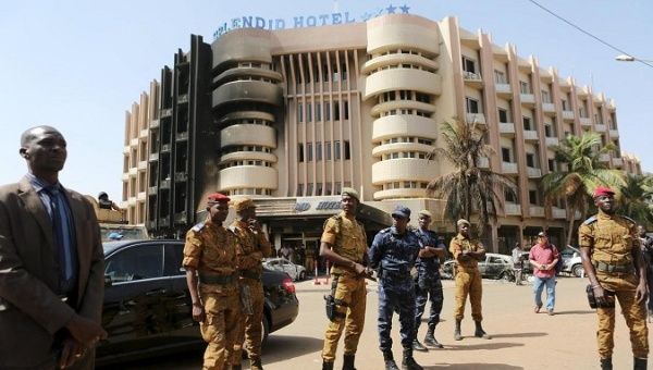Soldiers stand guard in front of the Splendid Hotel after an attack on the hotel and a restaurant in Ouagadougou, Burkina Faso, Jan. 18, 2016.