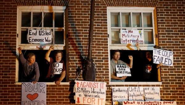 Supporters of Venezuelan President Nicolas Maduro, are seen at the window of the Venezuelan embassy after federal agents attempted to evict and arrest four Maduro supporters to end their multi-week occupation, in Washington, U.S.