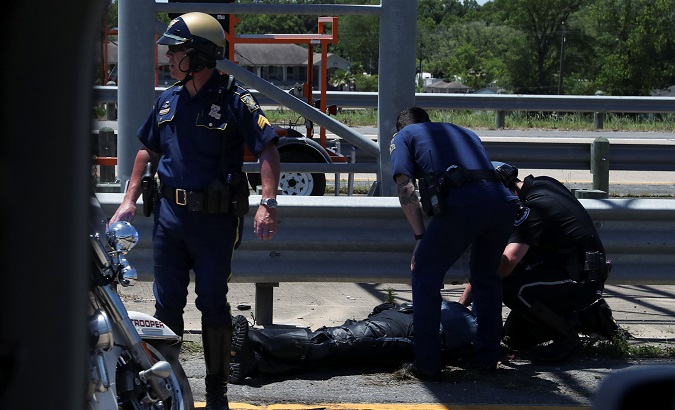 Police officers tend to fallen colleague after police motorcycle accident during Trump motorcade in Louisiana.