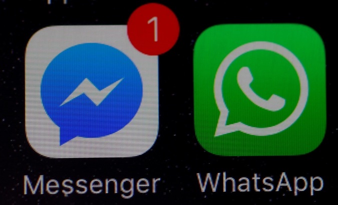 WhatsApp and Facebook messenger icons are seen on an iPhone.