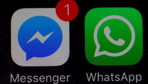 WhatsApp and Facebook messenger icons are seen on an iPhone.