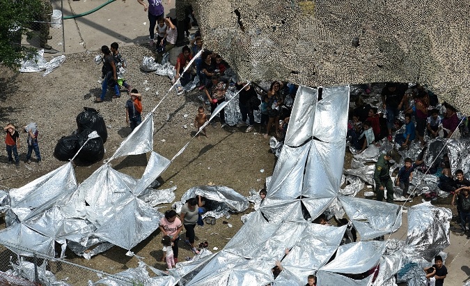 Migrants are seen outside the U.S. Border Patrol McAllen Station in a makeshift encampment in McAllen, Texas, U.S., May 15, 2019.