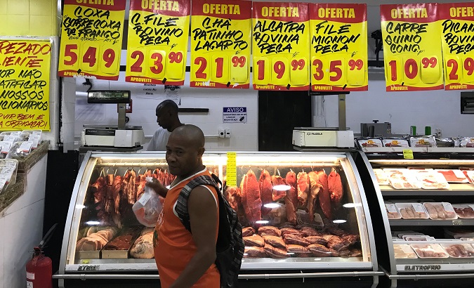 A customer buys meat at a supermarket in Rio de Janeiro