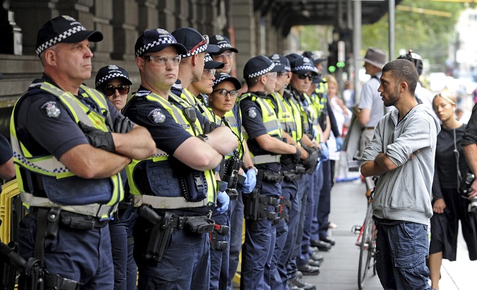 Victoria police officers stand guard outside Flinders St. station in Victoria, Australia.