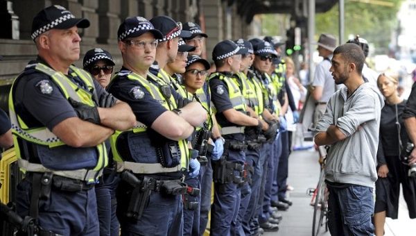 Victoria police officers stand guard outside Flinders St. station in Victoria, Australia. 