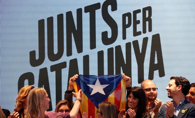 Junts x Catalunya members raise up a Catalan flag as they celebrate the results of the European Parliament elections in Barcelona, Spain