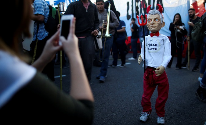 President Mauricio Macri as an IMF puppet during a teacher's protest in Buenos Aires, Argentina May 16, 2019.