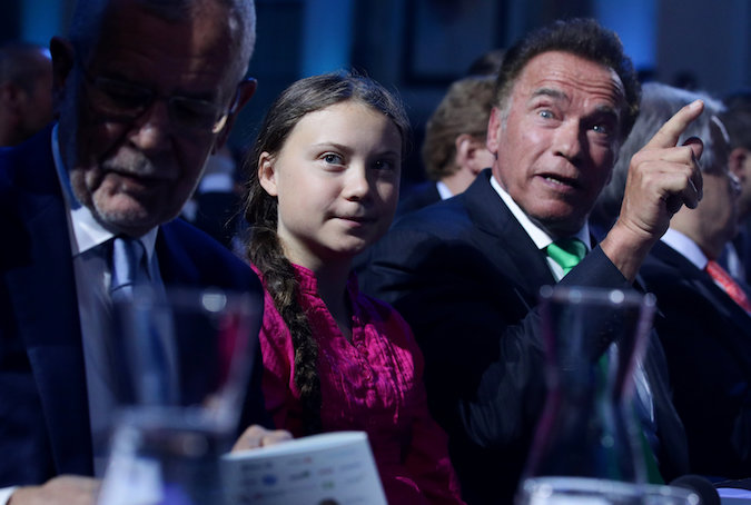 Former California Governor Arnold Schwarzenegger next to Swedish climate activist Greta Thunberg and Austrian President Alexander Van der Bellen in Vienna, Austria, May 28, 2019.