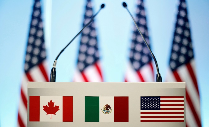 The flags of Canada, Mexico and the U.S. on a lectern before a joint news conference on the closing of the seventh round of NAFTA talks in Mexico City, Mexico March 5, 2018.