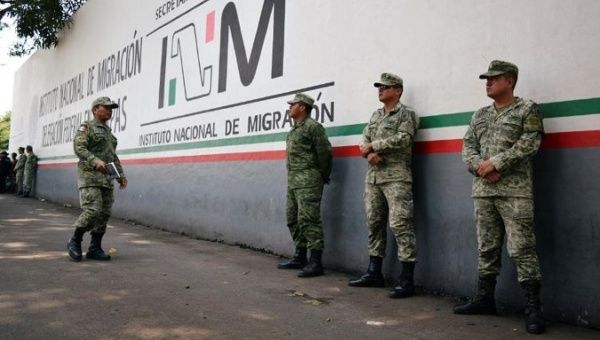 Soldiers assigned to the newly created National Guard keep watch outside the Siglo XXI immigrant detention center as part of the security measures by the federal government, in Tapachula, Mexico.