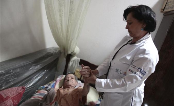 Cuban doctor Elisa Barrios Calzadilla inspects a patient during a house call in the city of Itiuba in the state of Bahia, northeastern Brazil November 20, 2013.