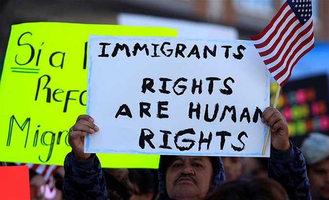 Demonstrators hold signs during a march by members of Border Network for Human Rights to protest against Trump''s proposed wall, in El Paso, Texas.