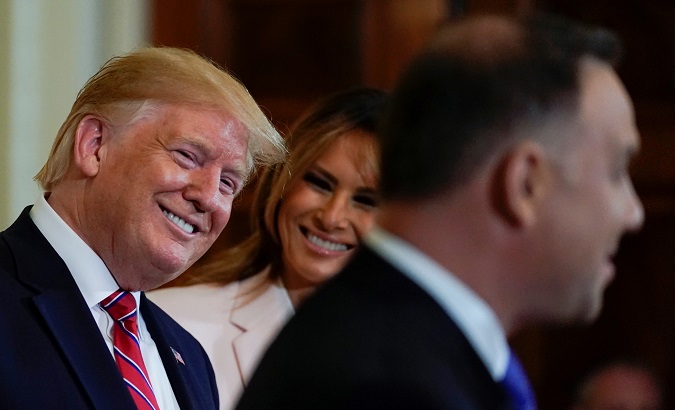 U.S. President Donald Trump and first lady Melania Trump react to remarks from Poland's President Andrzej Duda, June 12, 2019. REUTERS/Kevin Lamarque
