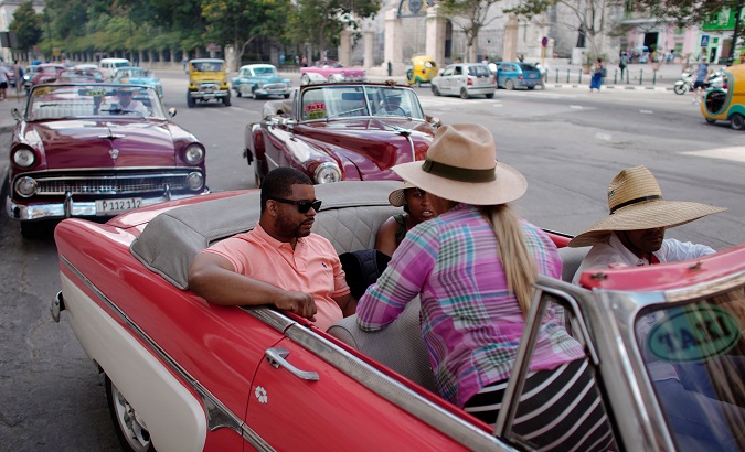 Cruise ship tourists prepare to ride in a vintage car in Havana, Cuba, June 5, 2019.
